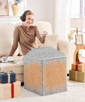 Woman using Under Desk Foot And Leg Warmer Space Heater Portable Quiet Personal Heater for home office, gray, with gifts nearby.