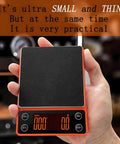 Hand holding Compact Portable Coffee Scale With Timer 3kg 0.1g High Precision Espresso Scale Rechargeable, orange design
