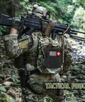 Survival First Aid Kit With 170 Pcs Emergency Medical Supplies for hiking camping backpacking shown on tactical backpack in forest