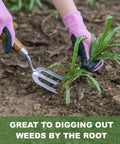 Heavy Duty Weeding Fork With Sharp Tines And Comfortable Wood Handle For Fast Weed Uprooting shown in use on garden weeds