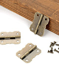 40 Pieces Mini Bronze Engraved Hinges Dope Retro Vibe for Crafts Vintage Style Replacement Cabinet Hinges on wood surface with screws