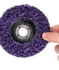 Six Pack 4 Inch Stripping Discs for Angle Grinder 5/8 Inch Arbor Rust and Paint Removal Wheel Silicon Carbide 46, purple disc held in hand.