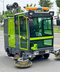 Heavy Duty Industrial Ride On Floor Sweeper Machine For Warehouses And Factories Powerful Walk Behind Cleaning Equipment With Custom Options To Keep Your Facility Spotless And Dust Free Efficient Operation For Large Spaces, green and gray ride-on design with dual side brushes.