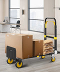 Upgraded 3-In-1 Folding Hand Truck Dolly For Home Office And Warehouse Converting From Two-Wheel Stair Climber To Four-Wheel Platform Cart Heavy Duty 600 Lb Capacity With Solid Wheels And Straps Orange in office with boxes