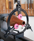 BMWOOD Woodturning MC-FS7 steady rest installed on a spindle lathe; black steel frame with pink rollers.