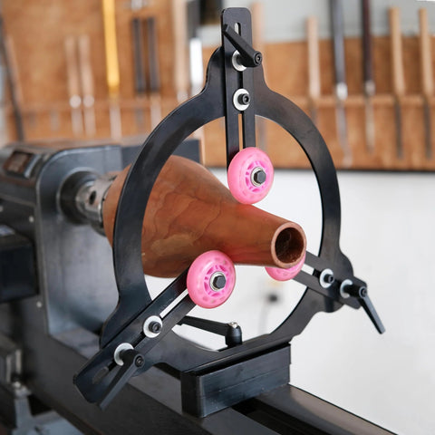 BMWOOD Woodturning MC-FS7 steady rest installed on a spindle lathe; black steel frame with pink rollers.