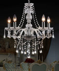 Raindrop Crystal Chandelier With K9 Glass Drops Modern Flush Mount Ceiling Light 5 Light Fixture illuminated over dining table.