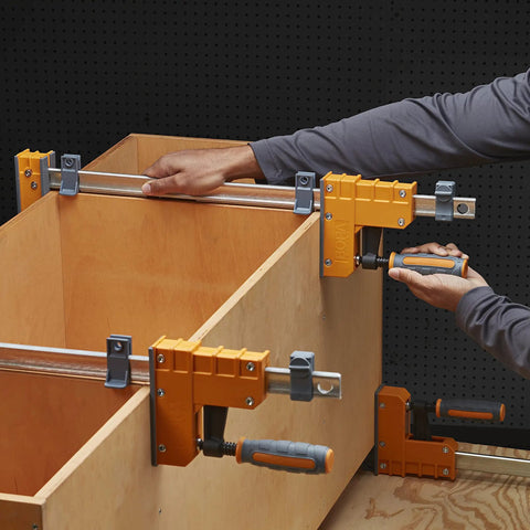 Top Shelf 18 Inch Parallel Clamps 2 Pack Woodworking Tools in use, applying even pressure on a wooden cabinet project.