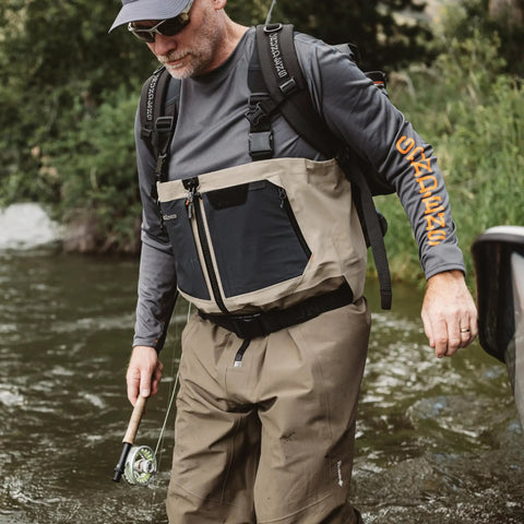 Man fishing with Rum Runner Gage Tech Waterproof Backpack For Fishing And Outdoors Fully Waterproof Angler Gear Carrier in river