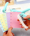 Person using One-Handed 2mm Circle Pattern Embosser With Built-In Waste Storage to punch designs on colorful paper, tool in sky blue.