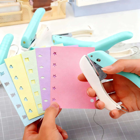 Person using One-Handed 2mm Circle Pattern Embosser With Built-In Waste Storage to punch designs on colorful paper, tool in sky blue.