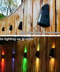 Top: Solar RGB Wall Lights For Outdoors Waterproof Fence And Stair Lighting 7 Color Changing LED Pathway Patio Garden Lights Auto Or Steady Color Modes Perfect For Backyard Garage Yard 8 Pack in daylight. Bottom: Lights illuminated at night in various colors on wooden fence.