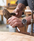 Person using a 16 Piece Punch And Chisel Set With Pin Punches And Center Punches For Metalwork, Auto Repair And DIY Projects on a workbench