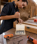 Knockout 5 Piece Forstner Bit Set For Woodworking That Booms With Precision on a workbench with a woman drilling wood.