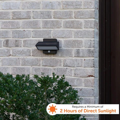 Architectural Outdoor Solar Wall Light With Motion Sensor on brick wall, aluminum bronze finish, compact size, daylight conditions