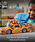Child playing with Technic Fast and Furious Toyota Supra Mk4 Building Kit for Kids and Teens Ages 9 Plus Realistic Engine Details.