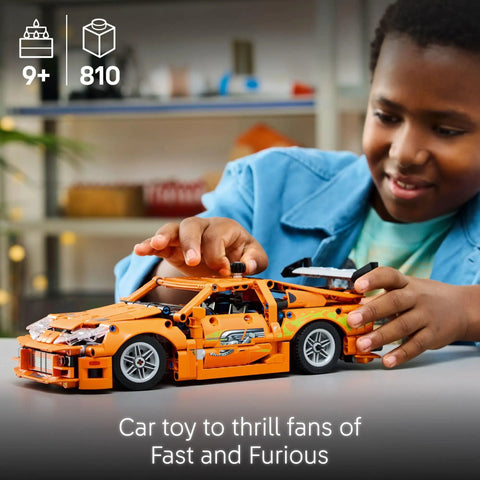 Child playing with Technic Fast and Furious Toyota Supra Mk4 Building Kit for Kids and Teens Ages 9 Plus Realistic Engine Details.