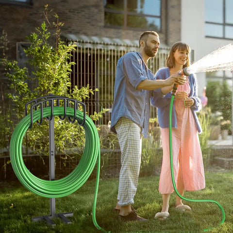 Couple using Detachable Metal Garden Hose Holder Stand With Upgraded Four Spike Design in yard