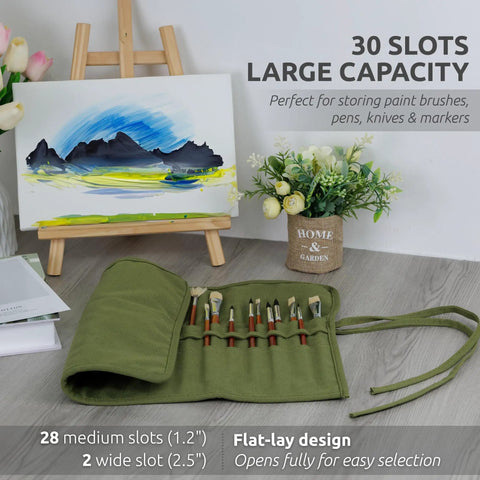 Image of the 30 Slot Roll Up Paint Brush Holder in army green, laid out fully on a table with paint brushes, in front of an easel.