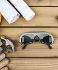 Heavy Duty Welding Safety Glasses With 10 Spare Lenses crafted for snug mask compatibility, resting on a wooden table.