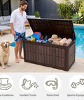 Man with dog using 134 Gallon Waterproof Resin Outdoor Deck Box with Lock, open, showing various outdoor essentials inside.