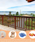 Pet Balcony Net For Cats And Dogs 16.5 Ft By 2.5 Ft Anti Fall Mesh Screen Black Keeps Your Fur Babies Safe On Patios And Stairs Easy Install With Buckles Or Rope visible on a balcony overlooking a scenic view.