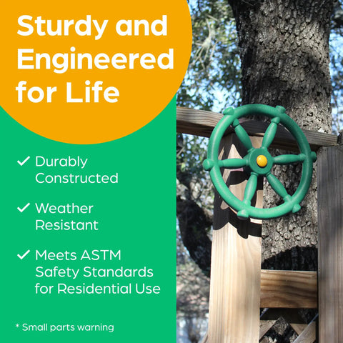 Green Pirate Ship Wheel Outdoor Playset Accessory mounted on treehouse rail