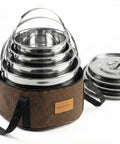 Compact Stainless Steel Camping Cookware Set With Travel Tote Bag, 4 Piece Campfire Pots And Pans Kit For Hiking, Beach, Barbecues, And Outdoor Adventures displayed stacked in a tote bag with lids on the side.