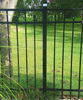 Solar Fence Post Cap Lights 2In By 2In Fits Wrought Iron And Aluminum Or Garden 8 Pack on black fence in a garden setting.