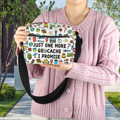 Just One More Geocache I Promise Crossbody Bag For Geocachers Gift held by a person, outdoor background, black strap