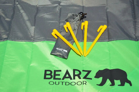 Lightweight Beach Tent Stakes Pack Of Four 5.9 Inch Sand Tarp Pegs With Anchor displayed on a green tarp