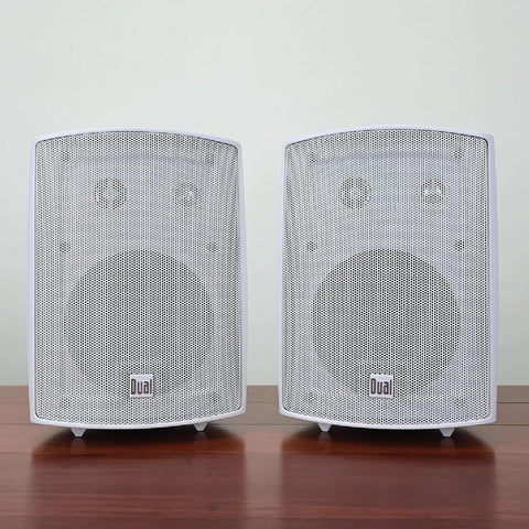 Five Point Twenty Five Inch Three Way Outdoor Indoor Wired Speakers with Weather Resistant Build displayed on wooden surface