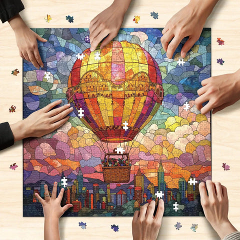Hands assembling stained glass hot air balloon 1000-piece jigsaw puzzle city in the clouds scene that slaps for game night
