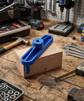 Rock Solid Magnetic Center Finder Tool For Woodworkers Needing Dead On Drill Layouts With Durable ABS Construction and Killer Precision Throughout Every Project on wood block, with tools in background.
