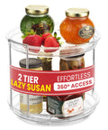 Clear acrylic two-tier rotating lazy Susan turntable with spice jars and jam jars on top shelf