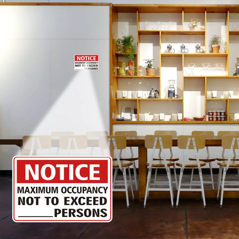 Maximum Occupancy Safety Sign Red For Restaurants And Businesses Durable Vinyl With Permanent Adhesive Waterproof UV Resistant 3 Mil Gloss Laminate Pack Of 2 displayed on wall in café