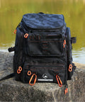 Fishing Backpack With Rod Holders And 42L Capacity, 900D Water-Resistant Oxford Tackle Bag for Men in Black Camo on rock