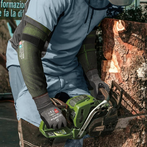 Man using chainsaw wearing Cut Resistant Arm Sleeves ANSI A9 For Men And Women With Puncture Protection, UPF50 Plus UV Blocking Cooling Sleeves