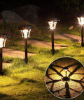 Four Eight Pack 25 Lumen Solar Powered Pathway Lights illuminating grass and stepping stones