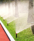 24 Piece Variable Arc Nozzles Replacement Pop Up Sprinker Heads Compatible With Standard Lawn Irrigation Systems spraying water on grass.