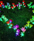 Heart-shaped display of Solar Garden Stake Lights 8 Pack With 32 Lily Flowers Waterproof 7 Color Changing LED Landscape Lights