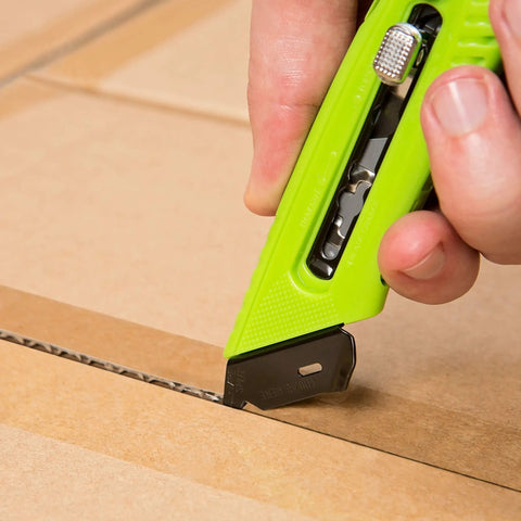 Close-up of Heavy Duty Box Cutter Utility Knife with Tape Splitter and Film Cutter cutting box, ergonomic handle, 3-position retractable blade.