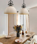 Dining area with Hines Pendant Light In Rubbed Bronze With Seeded Glass Transitional Ceiling Fixture over wooden table