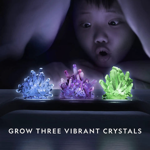Child amazed by Awesome Crystal Growing Kit For Kids With Light Up Display Stand Grow Three Vibrant Crystals In Blue Purple And Green STEM