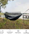 Double Tree Hammock With Built In Net For Camping And Travel set up by a lake with 20ft straps tied to trees.