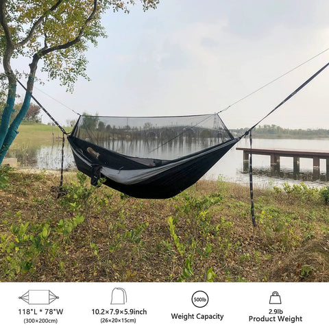 Double Tree Hammock With Built In Net For Camping And Travel set up by a lake with 20ft straps tied to trees.