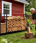 Man chopping wood beside Beefy 8Ft Firewood Rack With Heavy Duty Metal Frame And Built In Kindling Storage For Indoor And Outdoor Use