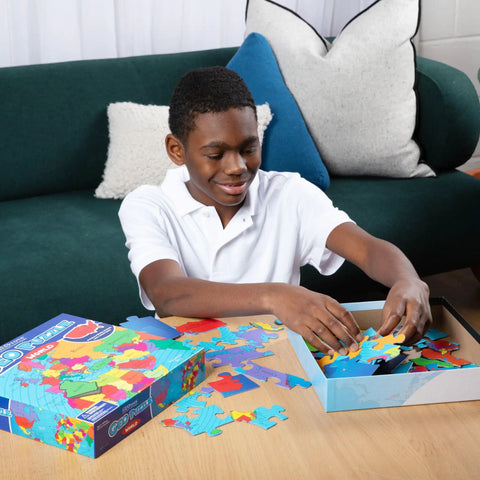 Child assembling World Map Geography Puzzle For Kids 68 Piece Educational Puzzle Game Learn Countries Capitals States And Provinces With Fun Maps Totally Kid Friendly Brain Boosting Learning Toy For Ages 6 To 9