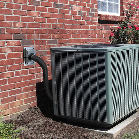 Tough As Nails Hvac Wall Penetration Cover And 3 Layer Insulated Line Set Sleeve Kit on AC condenser piping near brick wall.