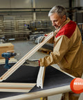 Man using Heavy Duty Work Bench Mat 23.5 By 47.5 By 0.06 Inch Scratch Resistant PVC Protects Your Workbench Table And Tool Station